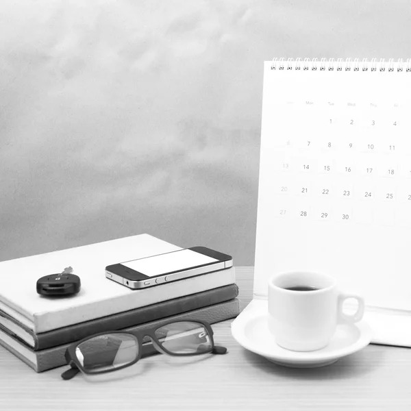Coffee and phone with car key,eyeglasses,stack of book,calendar