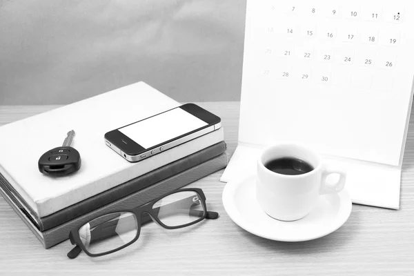 Coffee and phone with car key,eyeglasses,stack of book,calendar