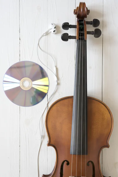 Top view of violin earphone and dvd disc