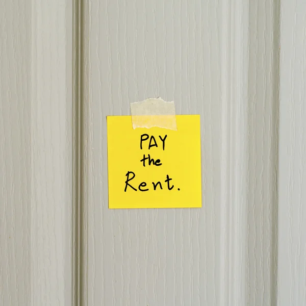 Sticky note write a message pay the rent