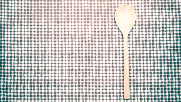 Wood spoon on kitchen towel