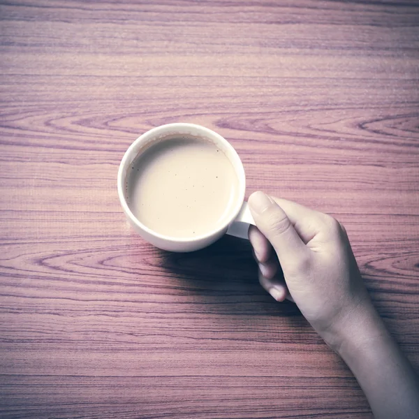 Hand holding coffee cup