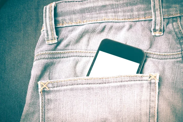 Smart phone in jean pocket retro vintage style