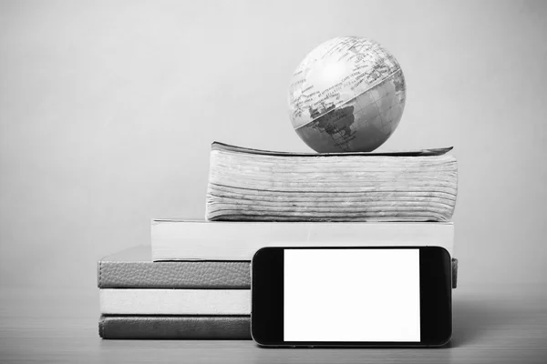 Book and earth ball with smart phone black and white color tone
