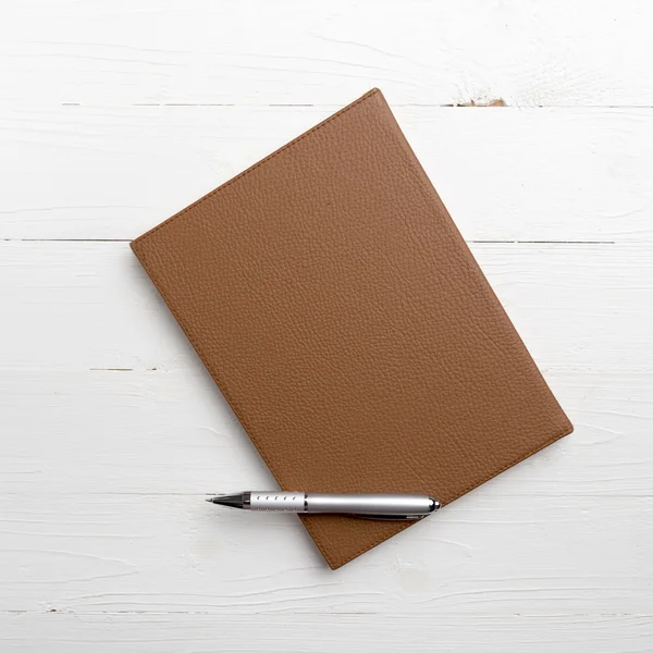 Brown notebook and pen