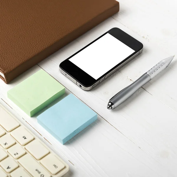 Computer and brown notebook with office supplies