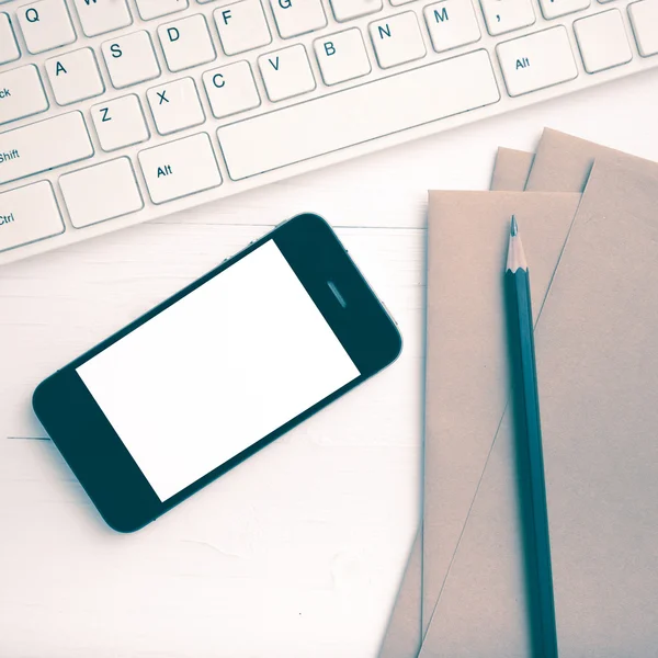 Computer and cellphone with brown paper and pencil vintage style