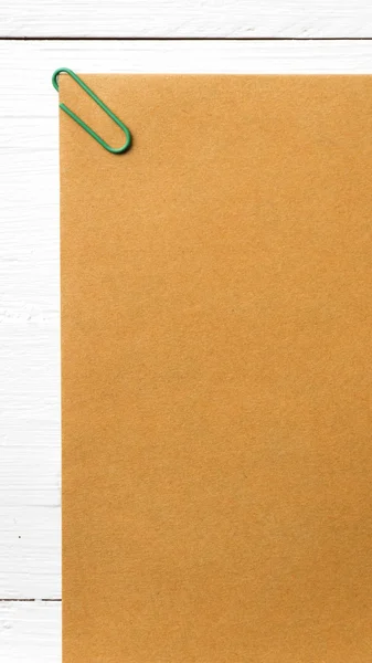 Brown paper with green paper clip