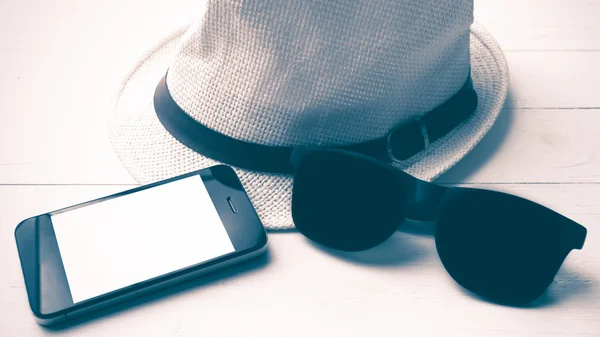 Hat sunglasses and smart phone vintage style