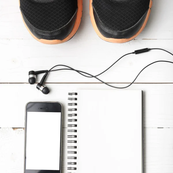 Running shoes,notebook and phone