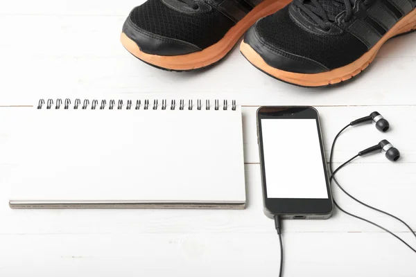 Running shoes,notebook and phone