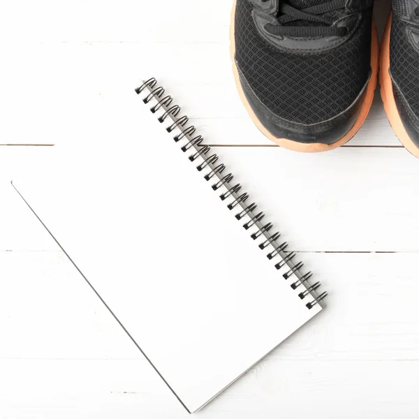 Running shoes and notepad