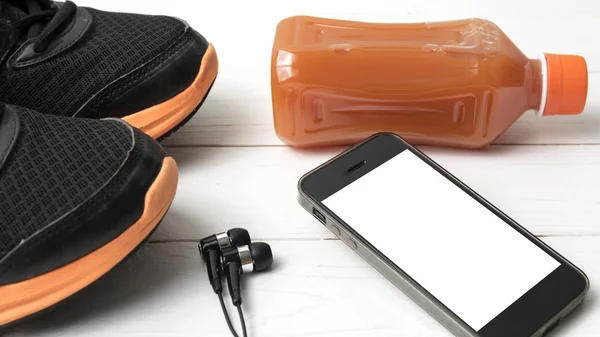 Running shoes,orange juice and phone