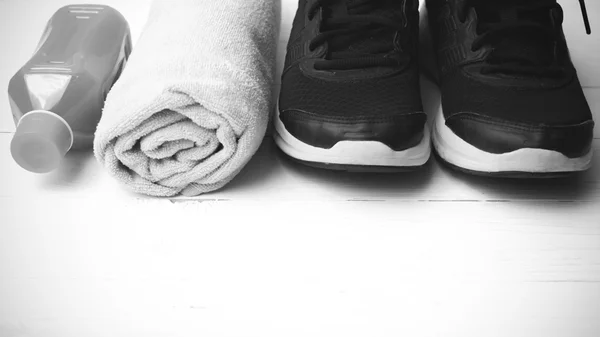 Running shoes,towel and orange juice black and white tone color