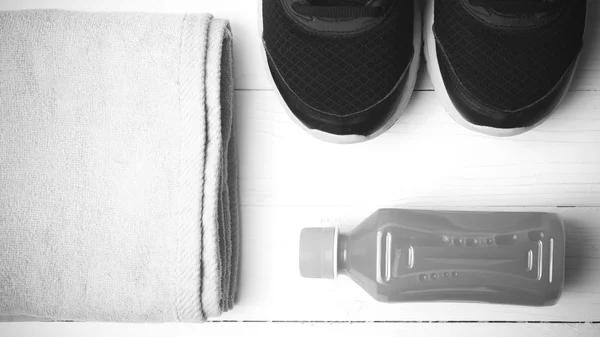 Running shoes,towel and orange juice black and white tone color