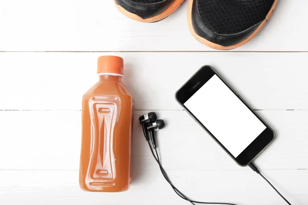 Running shoes,orange juice and phone