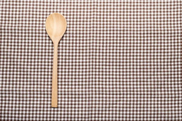 Wood spoon on kitchen towel