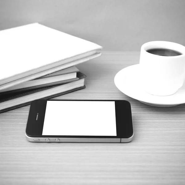 Coffee cup and phone and stack of book
