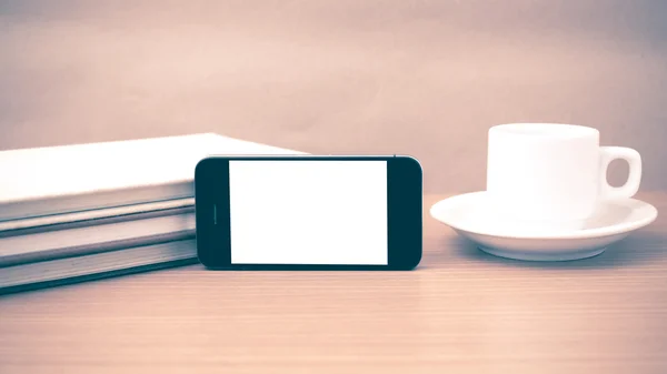 Coffee cup and phone and stack of book vintage style