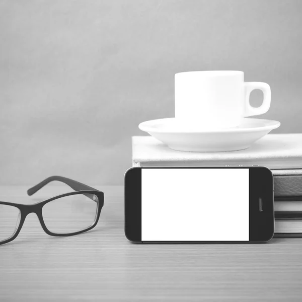 Coffee,phone,stack of book and eyeglasses