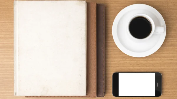 Coffee cup and phone and stack of book