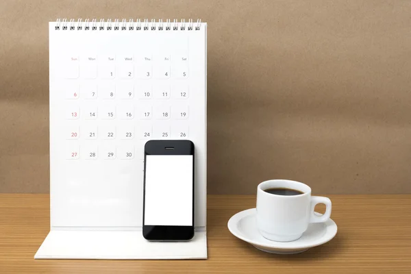 Coffee cup and phone and calendar