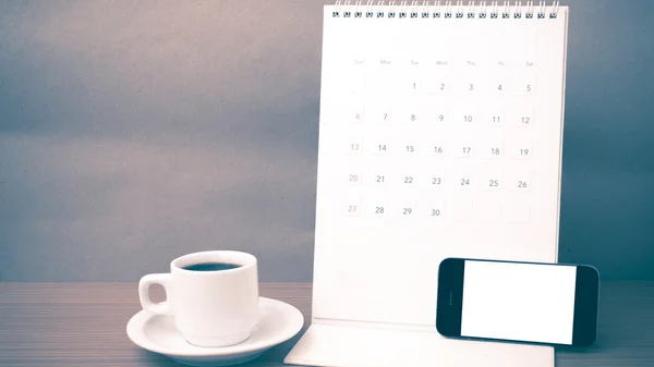 Coffee cup and phone and calendar