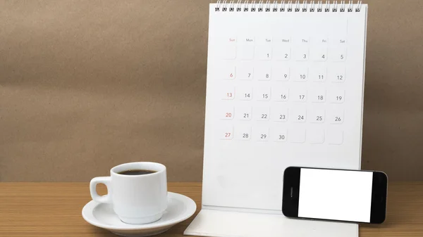 Coffee cup and phone and calendar