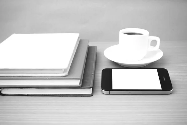 Coffee cup and phone and stack of book