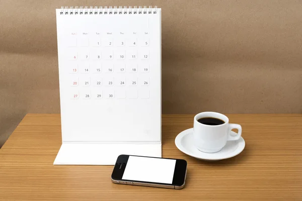 Coffee cup and phone and calendar