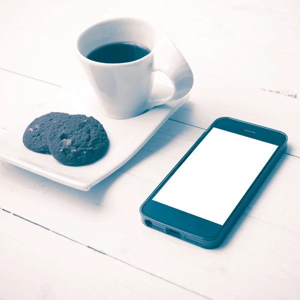 Coffee cup with cookie and phone vintage style