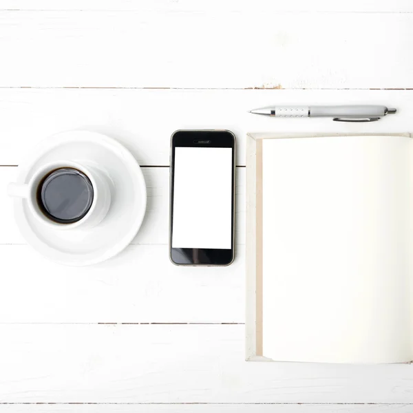Coffee cup with phone and notebook