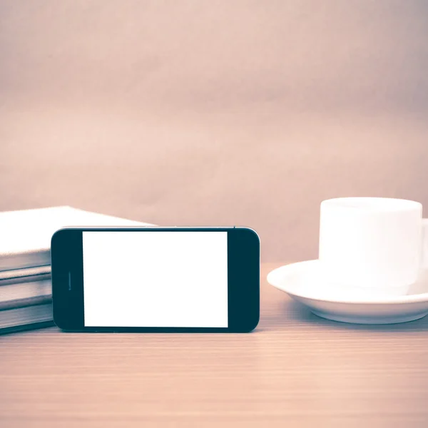 Coffee cup and phone and stack of book vintage style