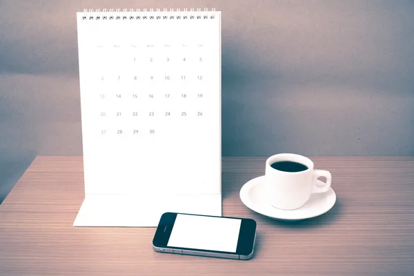 Coffee cup and phone and calendar