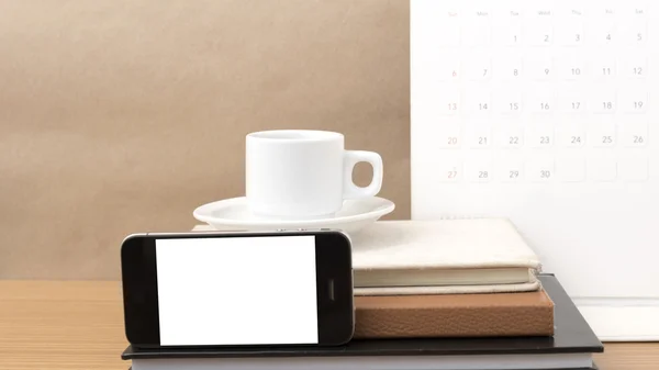 Coffee,phone,stack of book and calendar