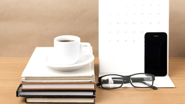 Coffee,phone,eyeglasses,stack of book and calendar