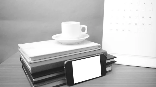 Coffee,phone,stack of book and calendar