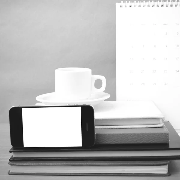 Coffee,phone,stack of book and calendar