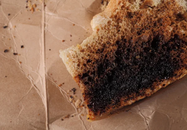 Burnt bread crumbs on a cardboard background