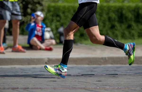 Runner legs and running shoe closeup of man, jogging outdoors Running shoes .