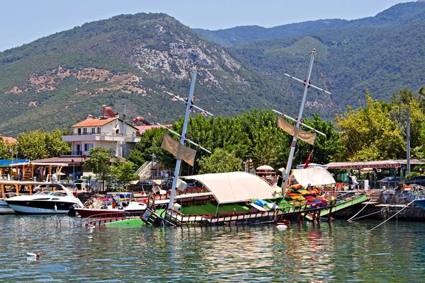Traditional wooden Gulet cruise boat sinks whilst in harbor