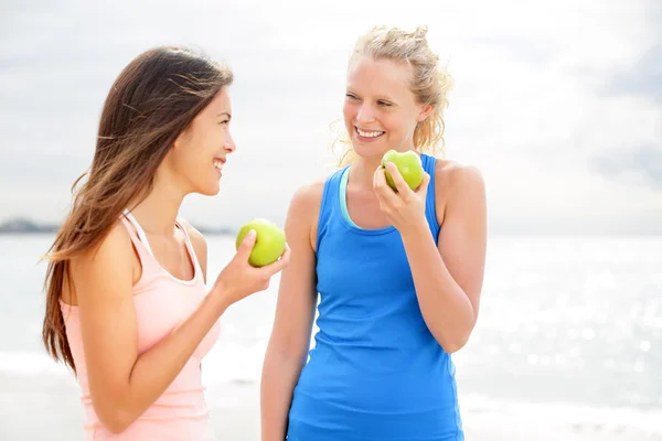 Women eating apple after running