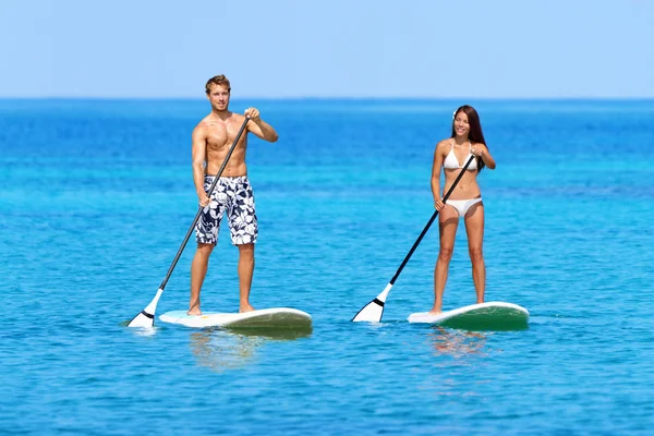 People on stand up paddle board