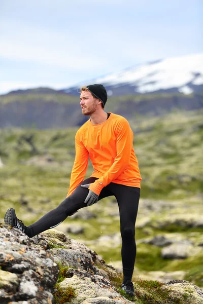 Runner stretching legs after running