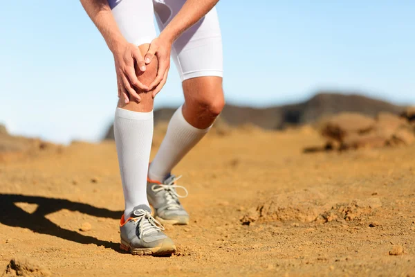 Man running outdoors. Sports injury