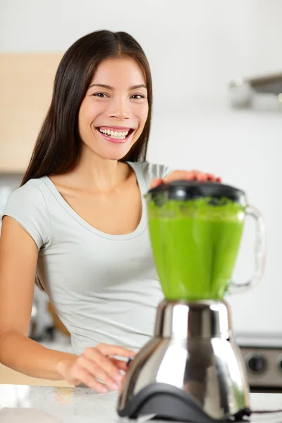Woman making vegetable green smoothies