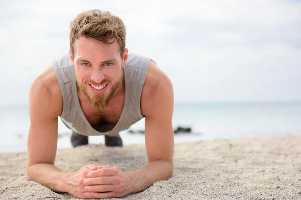 Fitness man doing plank outside