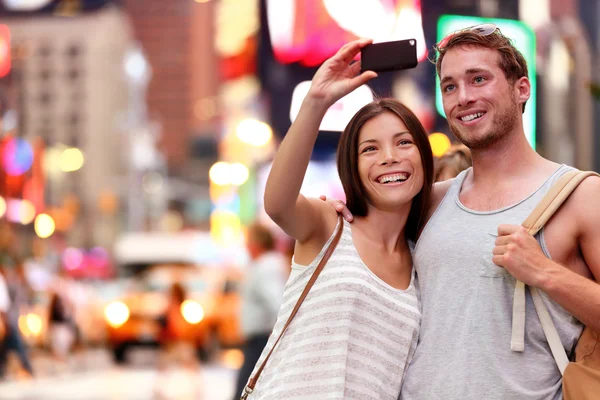 Couple taking smartphone selfie in New York