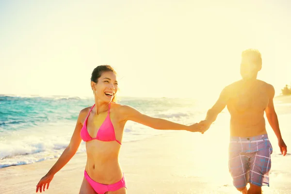 Couple laughing on tropical beach