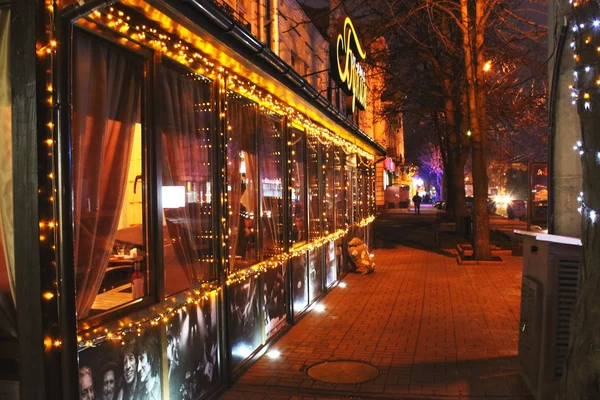 Sidewalk cafe lights at night